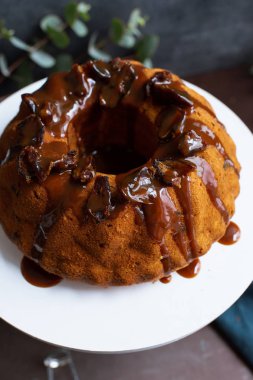 Tarih ve kek standı tuzlu karamel ile şenlikli Bundt kek. Yapışkan Toffee puding tarzı