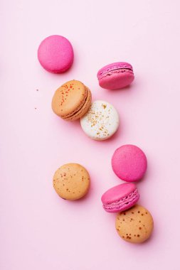 pembe arka plan üzerinde tatlı renkli macaroons. Üstte görüntü