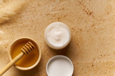 Küçük kapta krem ile traverten arka plan üzerinde Spa güzellik cilt bakımı mock-up. Üstte görüntü 