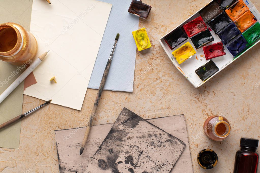 Artist workspace with art equipment on rustic background. Top view  