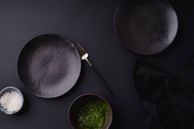 black empty plates with fork on dark background, Dinner setting template