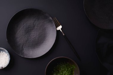 black empty plates with fork on dark background, Dinner setting template