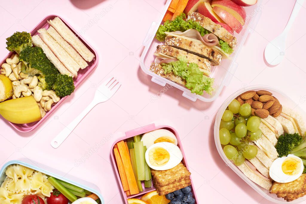 Top view pattern of school lunchboxes with various healthy nutritious meals on pink background