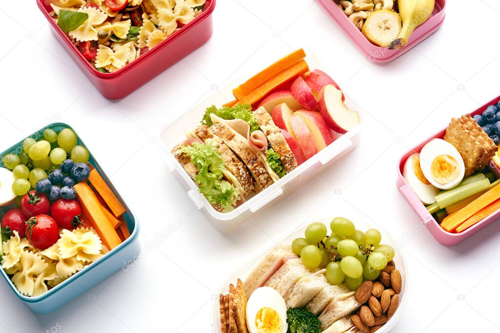 Top view pattern of school lunchboxes with various healthy nutritious meals on white background