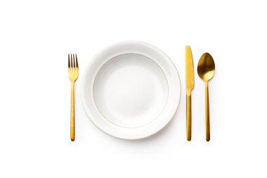 Düz beyaz tabak ve altın çatal bıçak takımı beyaz arka planda izole edildi. Üst görünüm 