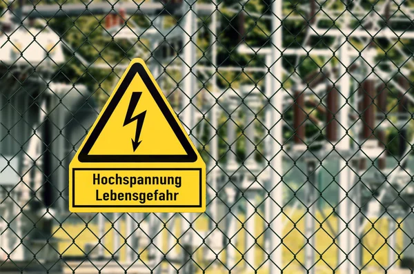 Electrical hazard sign placed on a fence of an electrical substation