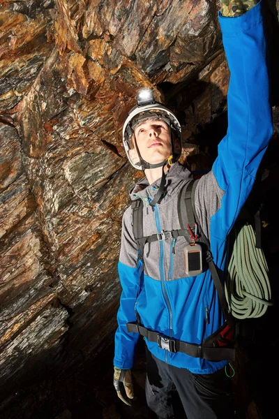 Young speleologist exploring a cave