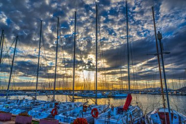Bulutlu gökyüzü günbatımı Harbor'da Alghero üzerinde. Sardunya, İtalya