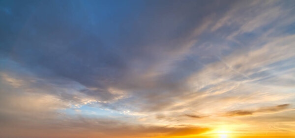 Sun shining through the clouds at sunset