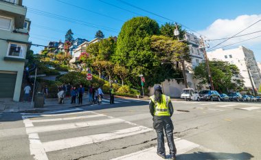 San Francisco, USA - October 30, 2016: Traffic enforcement agent in world famous Lombard street clipart