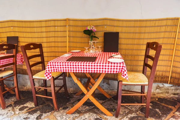 Picturesque tables and chairs in a narrow alley in old town Sorrento, Amalfi coast. Campania, Italy