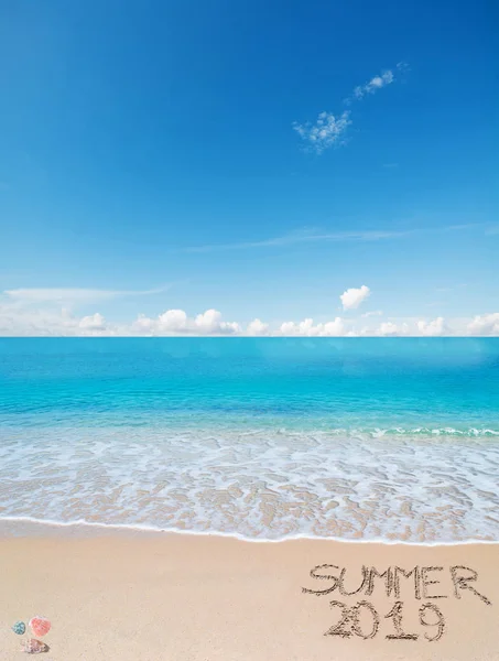 Summer 2019 written on a tropical beach under clouds — Stock Photo, Image