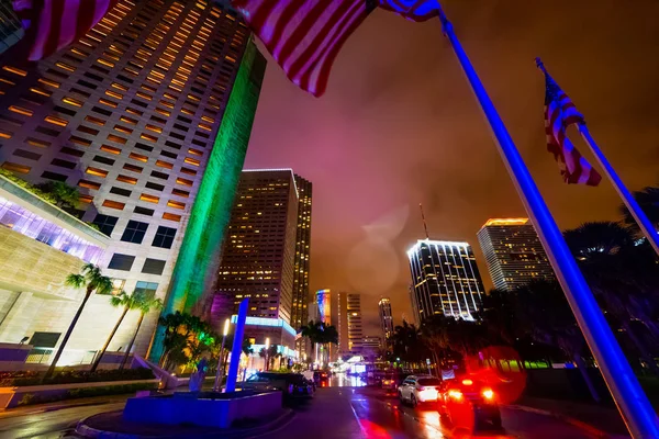 US flags and skyscrapers in Bayfront park in Miami at night