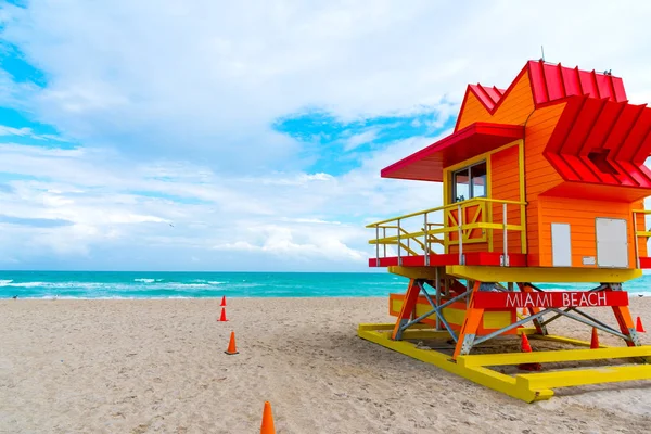 Colorful lifeguard hut under a cloudy sky in Miami Beach