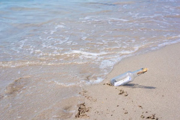 Close up of a message in a bottle on the shore