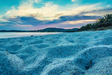 Gün batımında Maria Pia sahilinde beyaz kum. Sardunya, İtalya