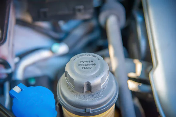 Close up of a Power Steering fluid tank of a car