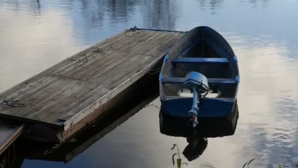 在浮桥上停泊着船外马达的旧船 — 图库视频影像