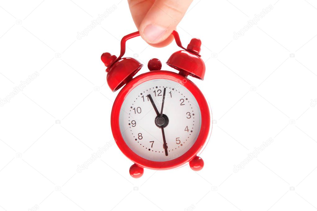 A small child holds his own mini alarm clock