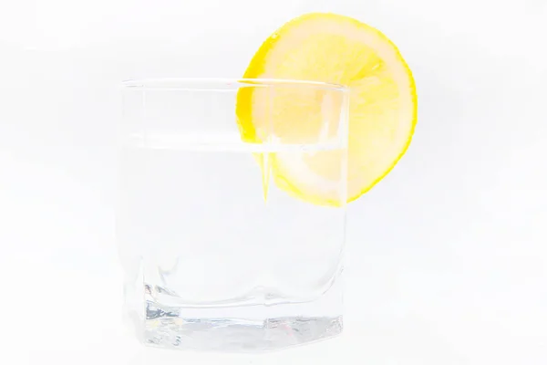 Slice of lemon on the glass isolated on the white — Stock Photo, Image