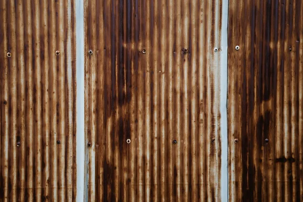 Old rusty wavy metal plate wall background