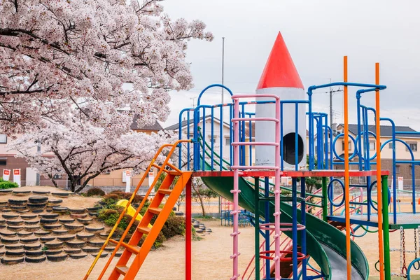 Colorful playground with cherry blossoms on park in Japan