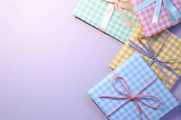Check pattern colorful gift boxes on purple background