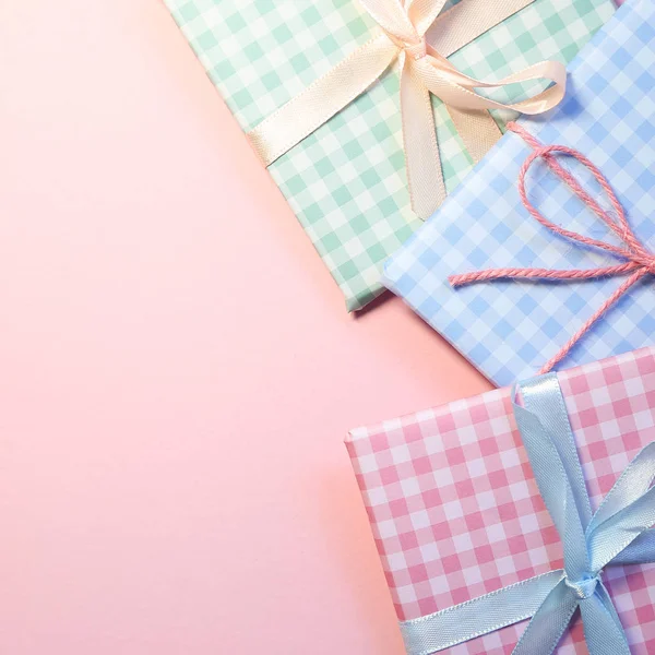 Check pattern colorful gift boxes on pink background