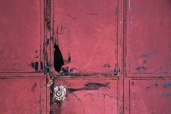 Old broken red metal door background