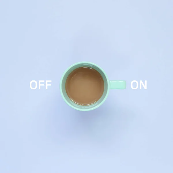 On and Off switch button. Cup of coffee on pastel purple background. top view