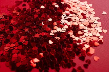 A large number of sparkles in the form of red hearts on a red background. Beautiful Valentine's Day Background clipart