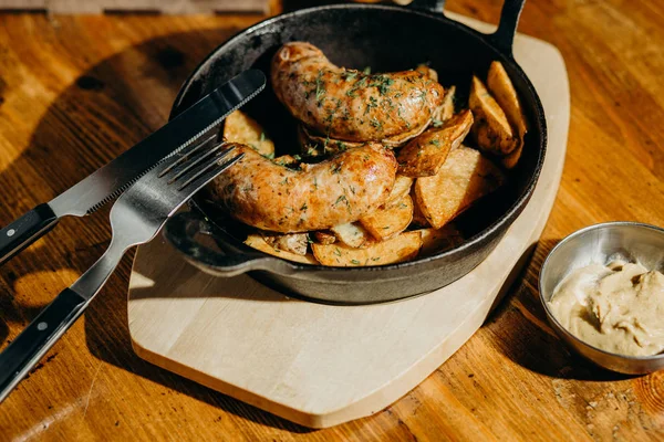 Variety of fatty foods and beer snacks on a wooden table.