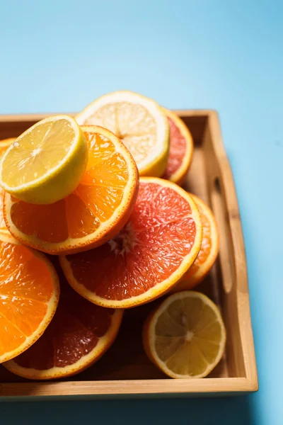 Cut in half juicy citruses on a blue background — Stock Photo, Image