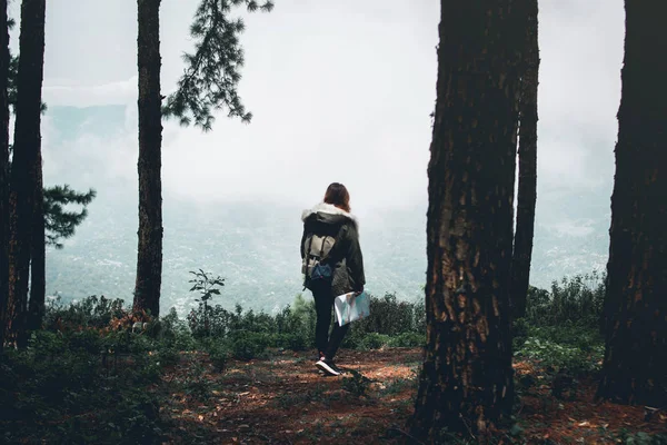 travel Jungle Woman and map in the forest