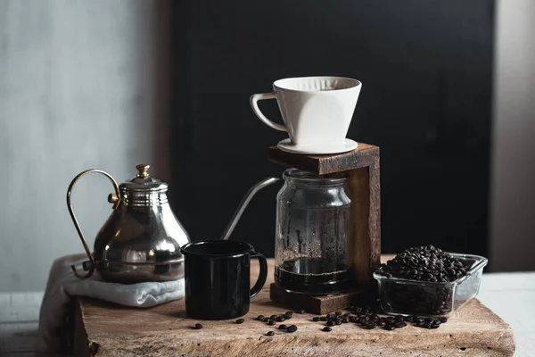 coffee In a glass bottle,Coffee drip,Hand holding a kettle Drip Coffee In the room