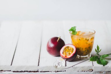 Bir cam şişe beyaz arka planda tutku meyve suyu