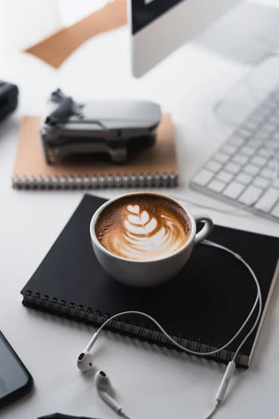 Latte coffee in a cup at the computer desk,Coffee on the desk at home