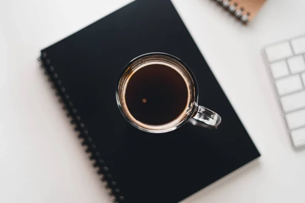 Black coffee in a cup at the computer desk,Coffee on the desk at home