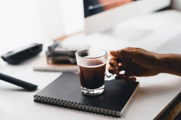 Black coffee in a cup at the computer desk,Coffee on the desk at home