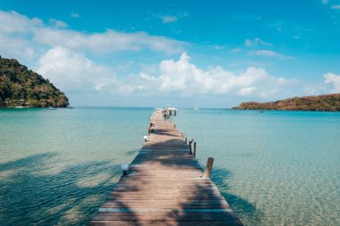 Sahildeki ahşap iskele ve Koh Kood 'daki berrak mavi su.