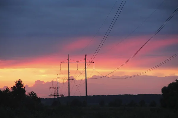 深紅色の雲と高電圧線と夕日 赤の減少 燃えるような雲と夜のパノラマ — ストック写真