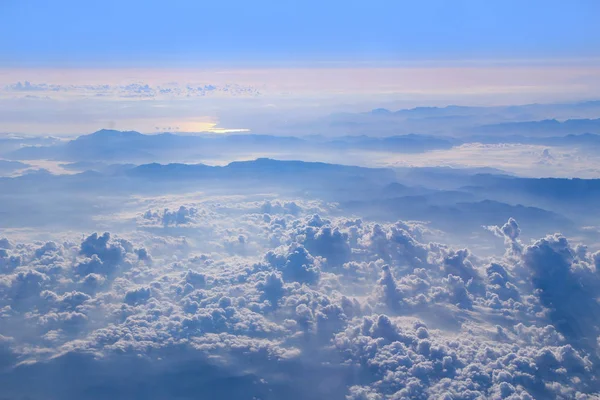 Flight above clouds. Wonderful panorama from window of plane with white clouds. Flying over white clouds. White clouds below. Beautiful panorama with heaven
