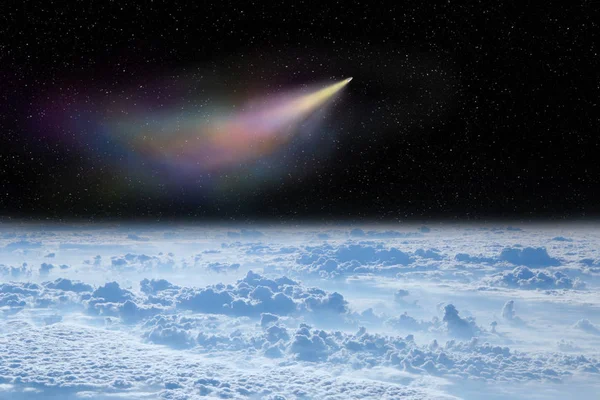 Comet flying in space over white clouds. Comet flying in space over planet Earth. Space landscape. Starry sky with falling comet above surface of Earth. View of clouds over Earth from space