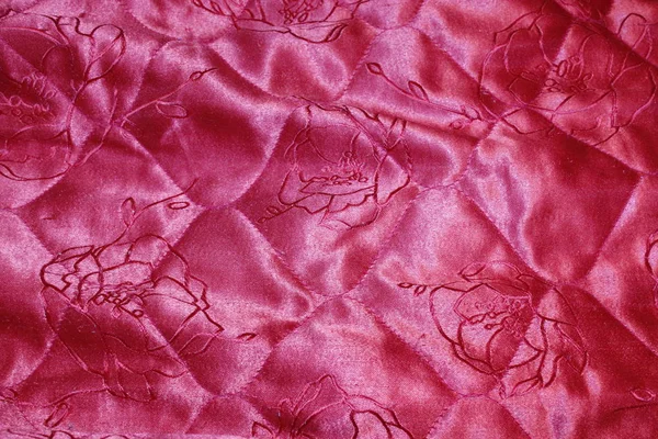 Texture on red coverlet with a pattern. Fabric texture — Stock Photo, Image