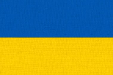 Ukrayna bayrağı. Kumaş yüzeyinde Ukrayna bayrağı. Kumaş dokusu. Arka planda Ukrayna 'nın ulusal sembolü. Ukrayna Cumhuriyeti. Avrupa ülkesi