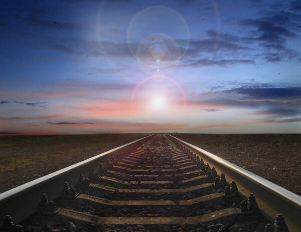 morning sun rising over the railway tracks. Sunrise on road. road to bright future. Hope for the best. Railway road and setting sun. Travel concept. Morning travel. Rails with natural landscape