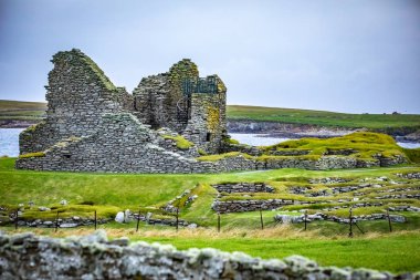 Scotland, Shetland Islands, Jarlshof is the best known prehistoric archaeological site in Shetland, Scotland. It lies near the southern tip of the Shetland Mainland and has been described as one of the most remarkable archaeological sites ever excava clipart