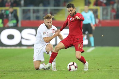 CHORZOW, POLAND - OCTOBER 11, 2018: UEFA Nations League 2019: Poland - Portugal o/p Bernardo Silva, Jakub Blaszczykowski clipart