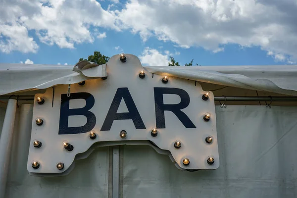 Bar sign with light bulps on tent