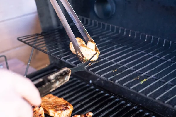 Gegrild vlees en groenten, barbecue zomer. Cook hands bereidt rokerige vlees op grill oven. Man grillen van vlees en champignons. Ruimte kopiëren — Stockfoto